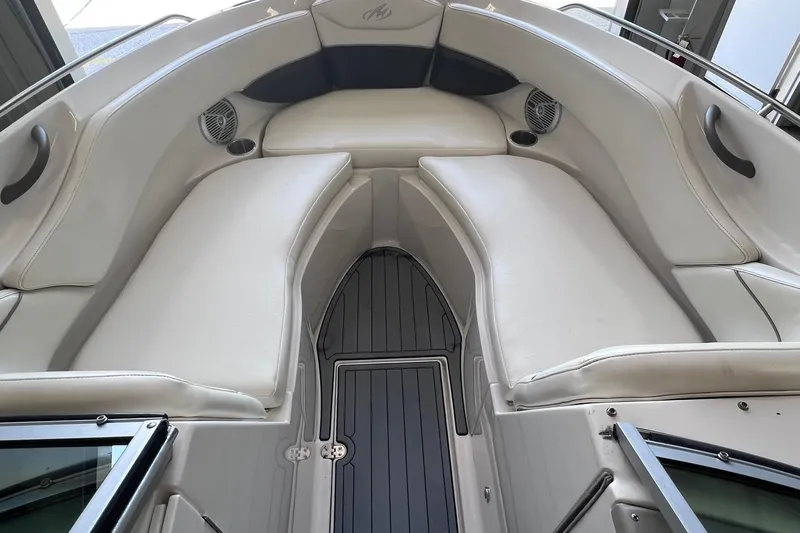 Slide: The Image of 2007 Monterey 248LS Montura Bowrider interior with white seating and sleek design. - 12