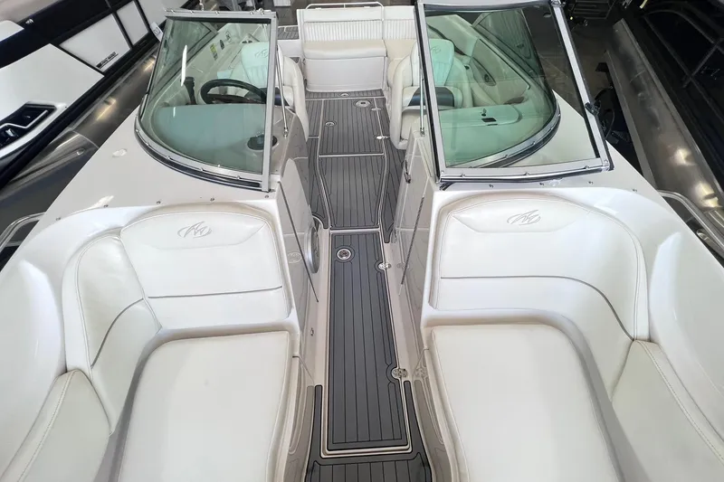 Slide: The Image of 2007 Monterey 248LS Montura Bowrider interior with white seating and sleek design. - 13