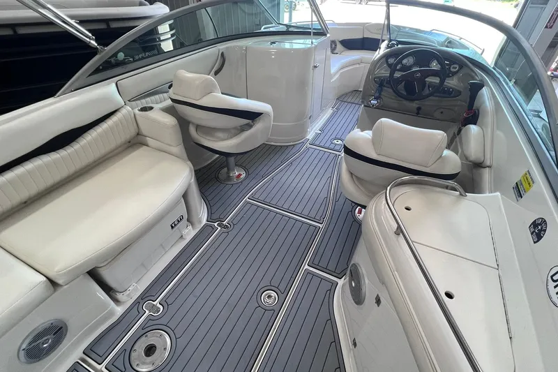 Slide: The Image of 2007 Monterey 248LS Montura Bowrider interior with white seating and sleek dashboard design. - 14