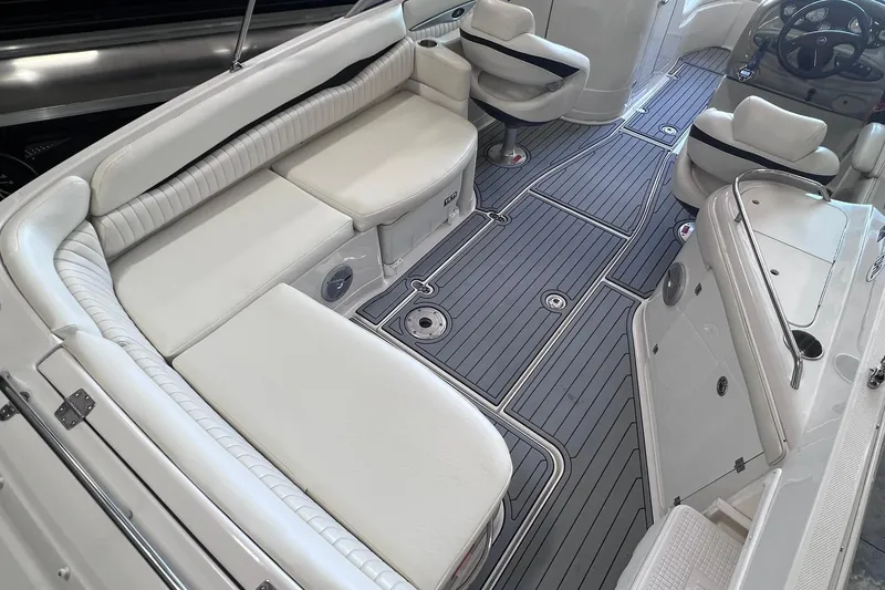 Slide: The Image of 2007 Monterey 248LS Montura Bowrider interior with white seating and sleek flooring. - 15