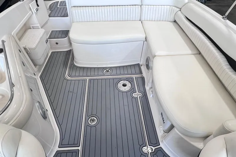 Slide: The Image of 2007 Monterey 248LS Montura Bowrider interior with white seating and gray flooring. - 16