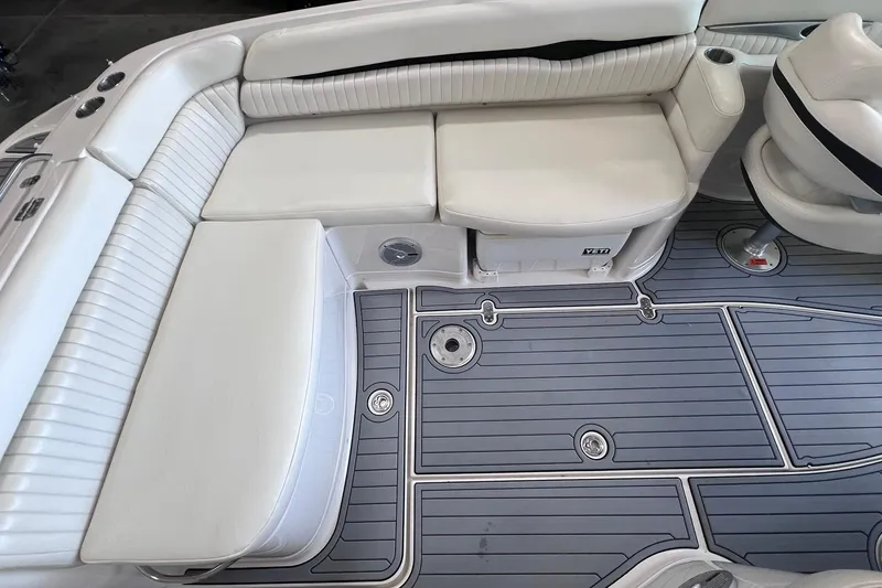 Slide: The Image of 2007 Monterey 248LS Montura Bowrider interior with white seating and gray flooring. - 17