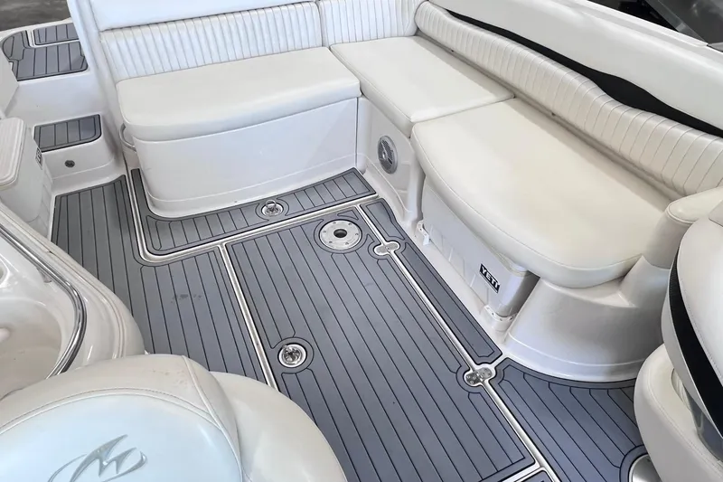 Slide: The Image of 2007 Monterey 248LS Montura Bowrider interior with white seating and gray flooring. - 18