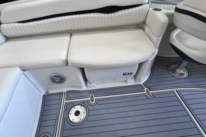 Slide: The Image of 2007 Monterey 248LS Montura Bowrider interior with white seating and Yeti cooler. - 21