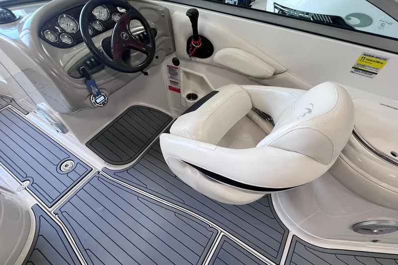 Slide: The Image of 2007 Monterey 248LS Montura Bowrider cockpit with steering wheel and white captain's chair. - 24