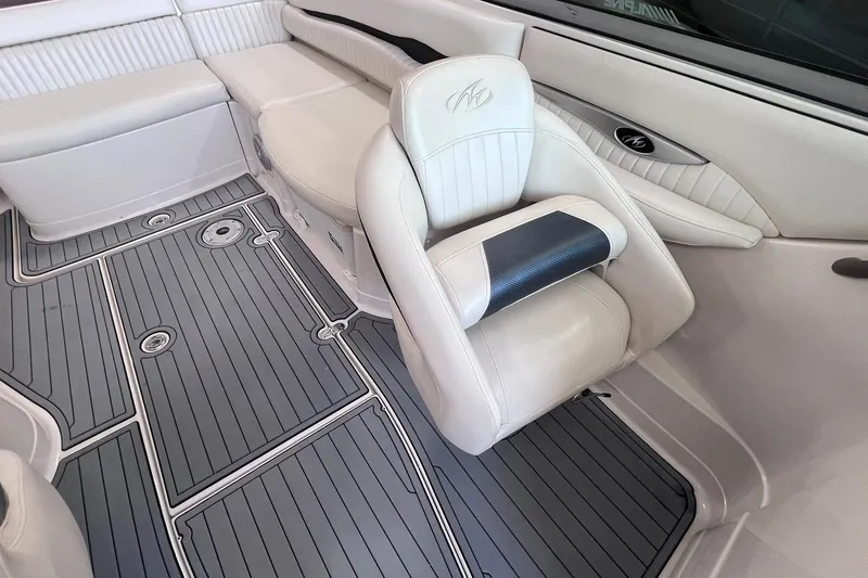 Slide: The Image of 2007 Monterey 248LS Montura Bowrider interior with white seating and gray flooring. - 26