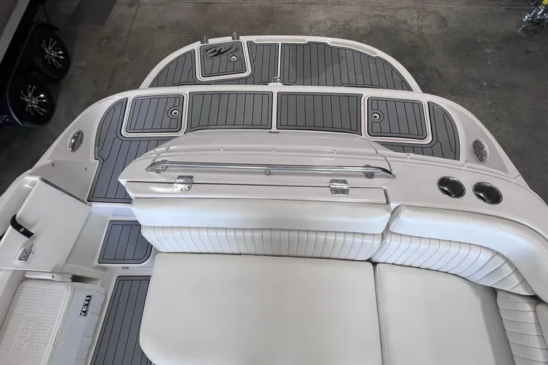 Slide: The Image of 2007 Monterey 248LS Montura Bowrider boat interior with cushioned seating and deck storage. - 28
