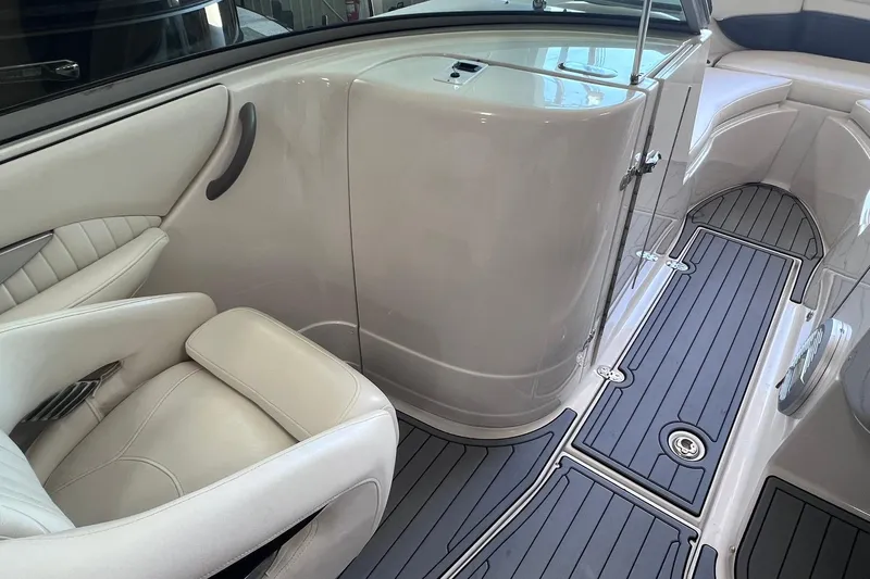 Slide: The Image of Interior of a 2007 Monterey 248LS Montura Bowrider, featuring sleek seating and modern flooring. - 29