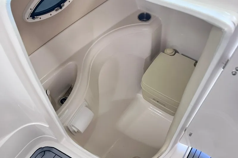 Slide: The Image of 2007 Monterey 248LS Montura Bowrider boat interior with compact marine toilet. - 30