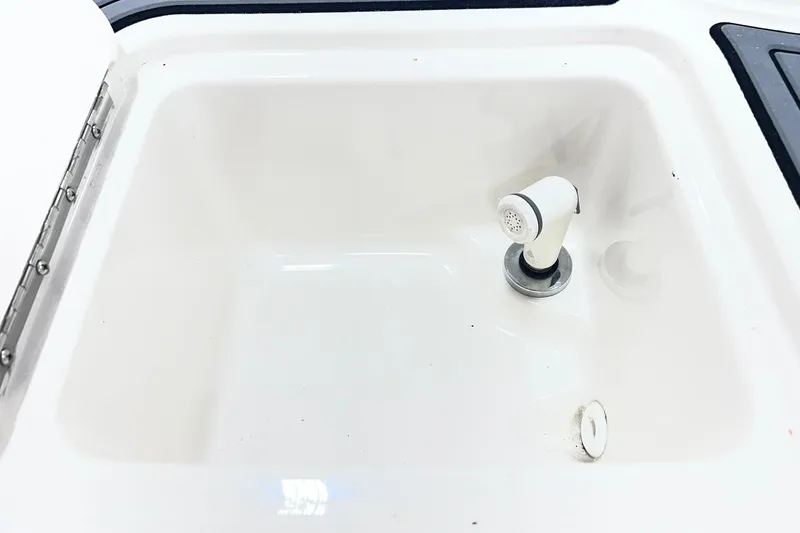 Slide: The Image of 2007 Monterey 248LS Montura Bowrider sink with faucet in white compartment. - 45
