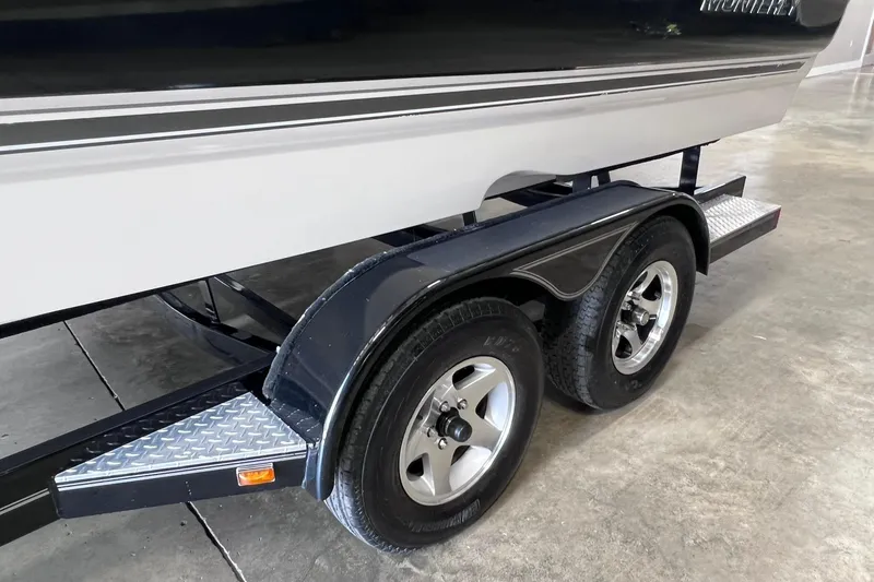 Slide: The Image of 2007 Monterey 248LS Montura Bowrider on dual-axle trailer in a garage setting. - 47