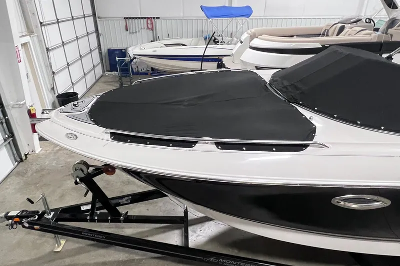 Slide: The Image of 2007 Monterey 248LS Montura Bowrider in storage, covered and on a trailer. - 51