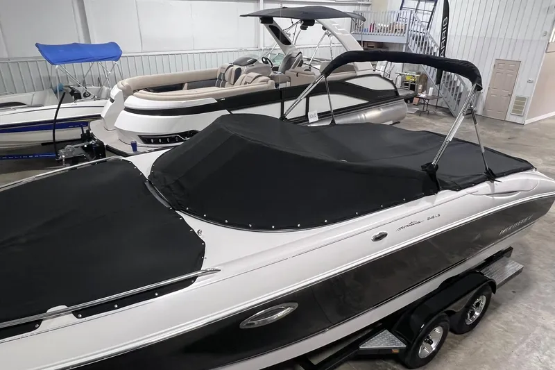 Slide: The Image of 2007 Monterey 248LS Montura Bowrider with black cover in showroom. - 52