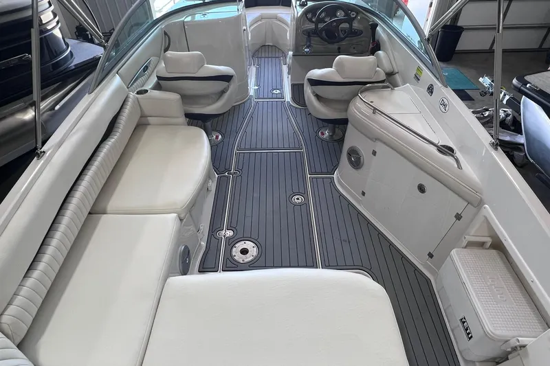 Slide: The Image of 2007 Monterey 248LS Montura Bowrider interior with white seating and sleek gray flooring. - 7