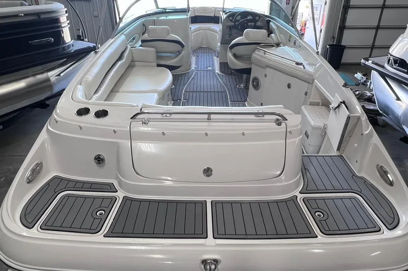 Slide: The Image of 2007 Monterey 248LS Montura Bowrider interior with seating and helm in a garage setting. - 8