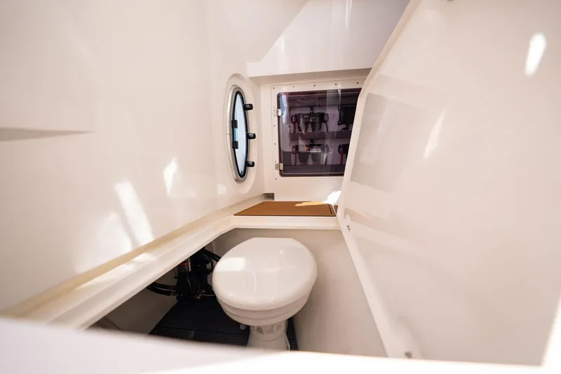 Slide: The Image of Compact bathroom interior of 2026 MVI Invicta 30OC boat with porthole window. - 24