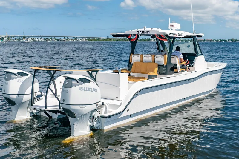 Slide: The Image of 2026 MVI Invicta 30OC boat with Suzuki engines on open water. - 6