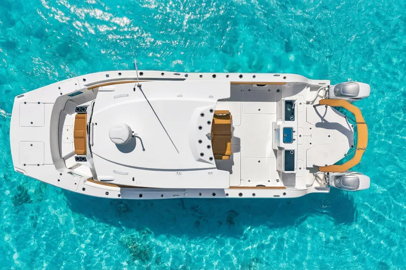Slide: The Image of Aerial view of 2026 MVI Invicta 30OC boat on clear turquoise water. - 3