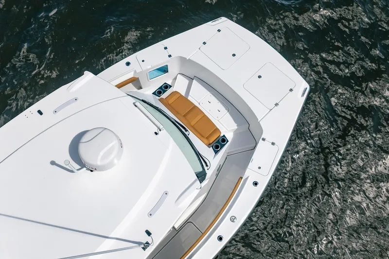 Slide: The Image of Aerial view of 2026 MVI Invicta 30OC boat on water, featuring sleek design and seating. - 13