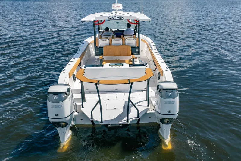Slide: The Image of 2026 MVI Invicta 30OC boat with dual Suzuki 350 engines on open water. - 5