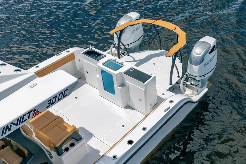 Slide: The Image of 2026 MVI Invicta 30OC boat with dual Suzuki engines on water. - 9