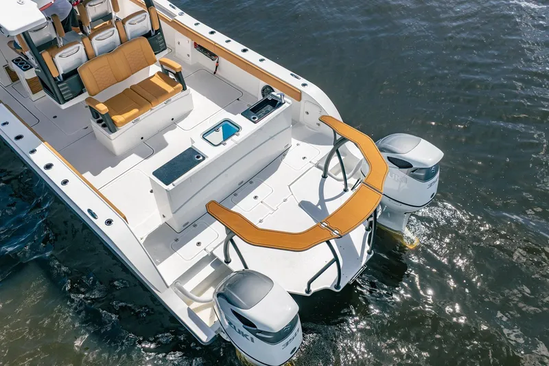Slide: The Image of Aerial view of 2026 MVI Invicta 30OC boat with dual engines on water. - 10