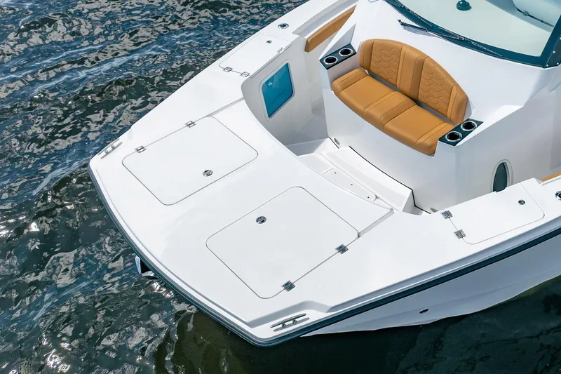 Slide: The Image of 2026 MVI Invicta 30OC boat with tan seating, sleek white deck, and cup holders. - 14