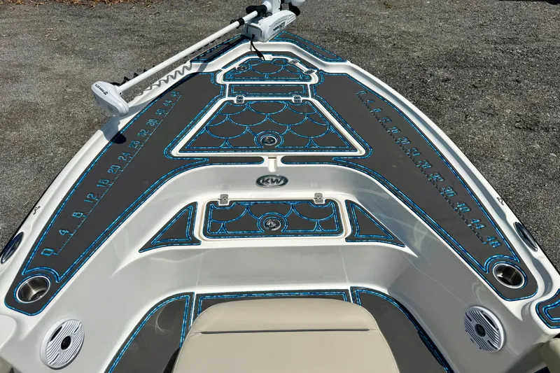 Slide: The Image of 2023 Key West 188 Bay Reef boat deck with custom blue and gray padding. - 11