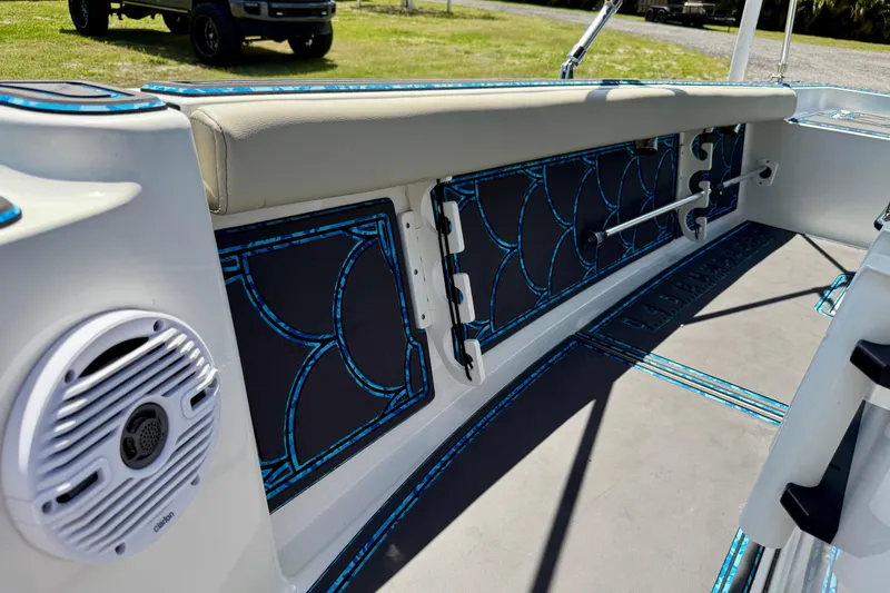 Slide: The Image of 2023 Key West 188 Bay Reef boat interior with stylish blue accents and speaker. - 13