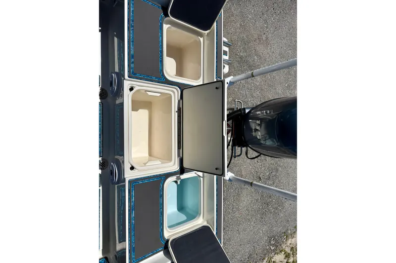 Slide: The Image of 2023 Key West 188 Bay Reef boat deck with storage compartments and motor. - 22
