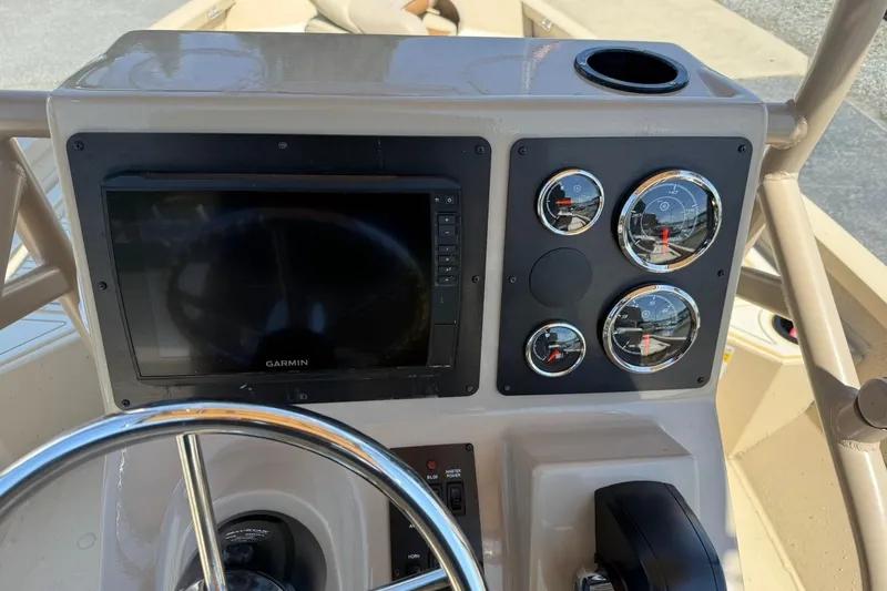 Slide: The Image of 2022 G3 Bay 18 GX boat dashboard with Garmin display and gauges. - 11
