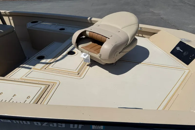 Slide: The Image of 2022 G3 Bay 18 GX boat interior with beige seating and deck layout. - 7