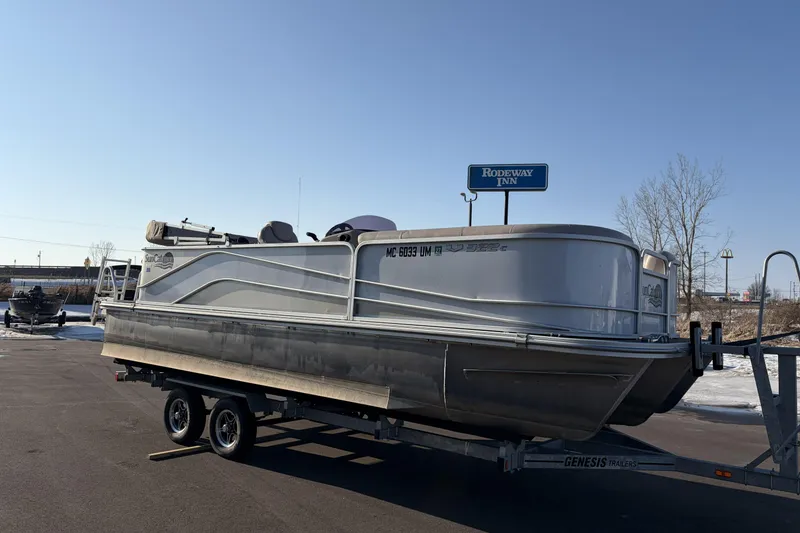 The Image of 2019 SunCatcher V322 Cruise pontoon boat on trailer, parked near Rodeway Inn. - 0