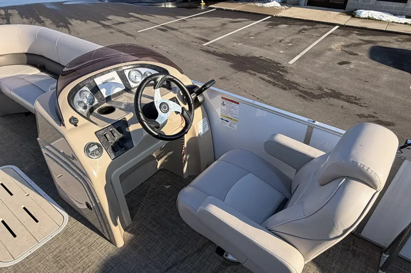 Slide: The Image of 2019 SunCatcher V322 Cruise boat interior with steering wheel and seating. - 14
