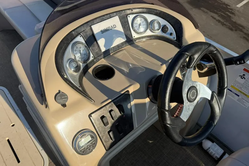 Slide: The Image of 2019 SunCatcher V322 Cruise boat dashboard with steering wheel and gauges. - 15