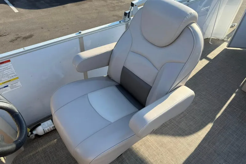 Slide: The Image of Captain's chair on 2019 SunCatcher V322 Cruise pontoon boat, featuring plush gray upholstery. - 17
