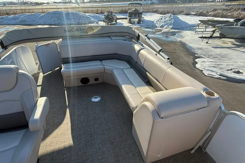 Slide: The Image of 2019 SunCatcher V322 Cruise pontoon boat with beige seating and snowy background. - 21