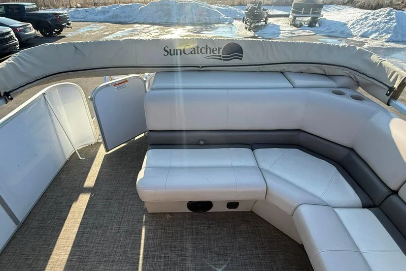 Slide: The Image of 2019 SunCatcher V322 Cruise pontoon boat interior with cushioned seating and cup holders. - 23