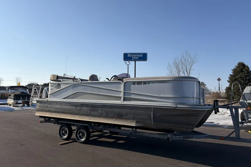 Slide: The Image of 2019 SunCatcher V322 Cruise pontoon boat on trailer near Rodeway Inn. - 3