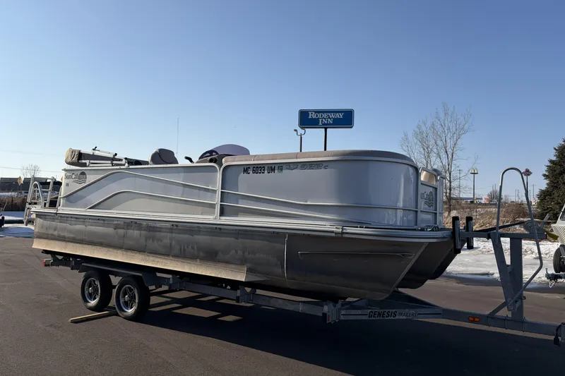 Slide: The Image of 2019 SunCatcher V322 Cruise pontoon boat on trailer, parked near Rodeway Inn. - 4