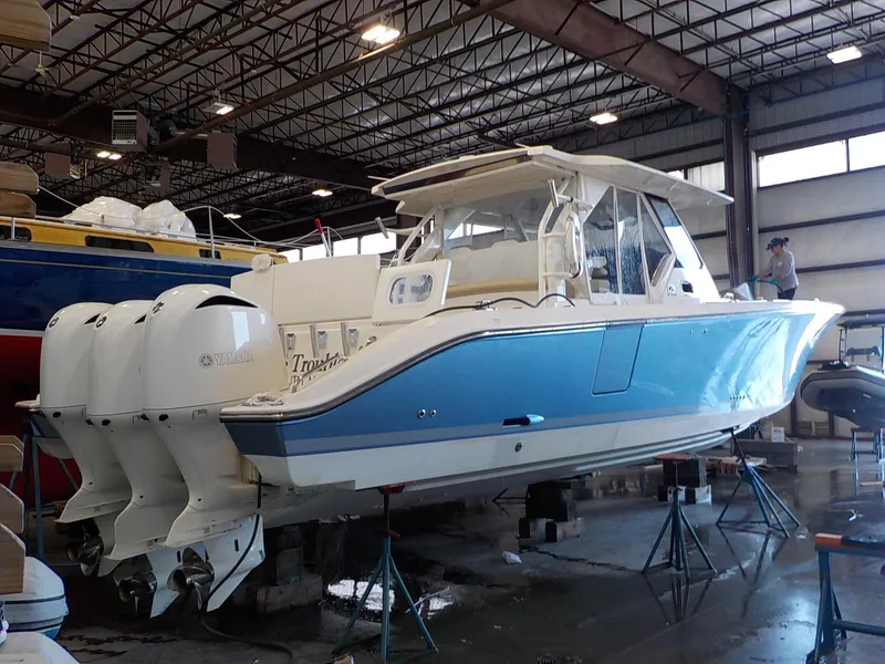 Slide: The Image of 2017 Pursuit S 408 Sport boat elevated in warehouse. - 2