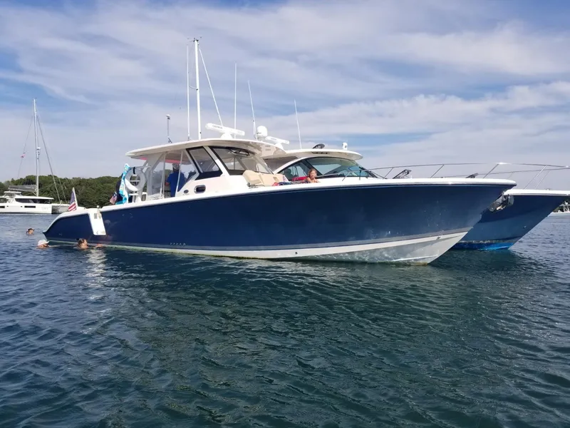 Slide: The Image of 2017 Pursuit S 408 Sport boat on calm water. - 4