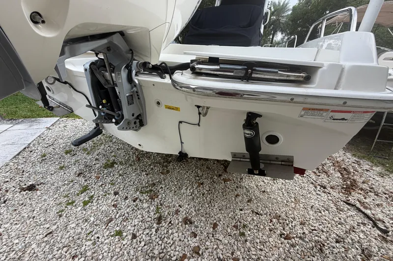 Slide: The Image of 2019 Boston Whaler 210 Dauntless boat stern view with motor and trim tabs. - 11