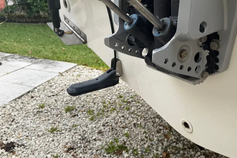 Slide: The Image of 2019 Boston Whaler 210 Dauntless boat engine mount detail on gravel surface. - 12