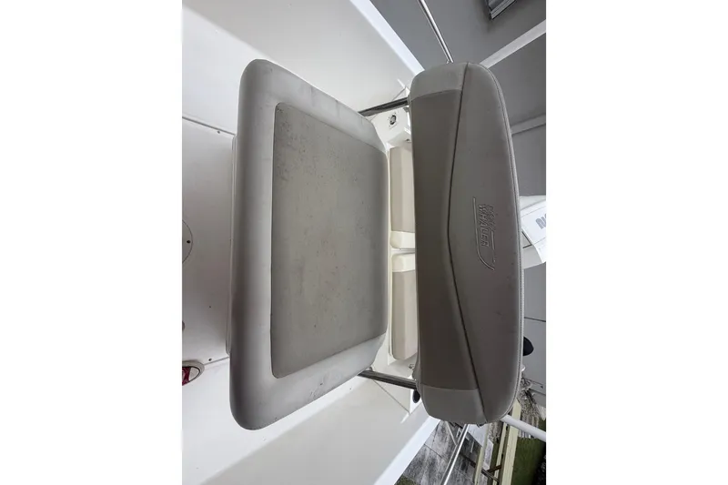 Slide: The Image of Boston Whaler 210 Dauntless 2019 boat seat, featuring gray upholstery and branded logo. - 27