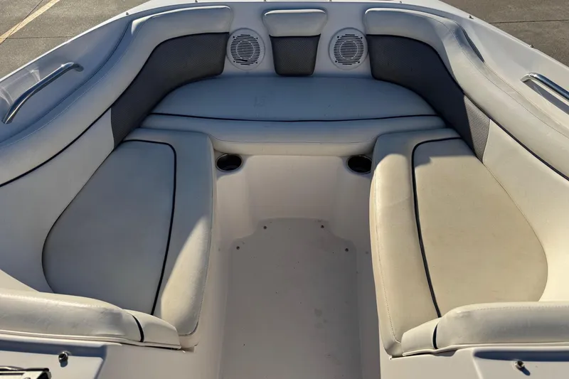 Slide: The Image of 2009 Hurricane SunDeck 210 IO boat interior with cushioned seating and cup holders. - 11