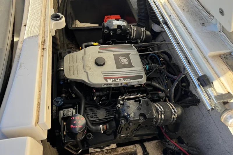 Slide: The Image of Engine compartment of a 2009 Hurricane SunDeck 210 IO boat, featuring a 350 MAG engine. - 13