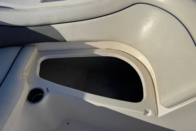 Slide: The Image of 2009 Hurricane SunDeck 210 IO boat interior storage compartment with cup holder. - 14