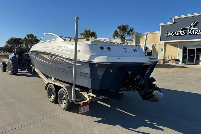 Slide: The Image of 2009 Hurricane SunDeck 210 IO boat on trailer outside Angler's Marine store. - 2