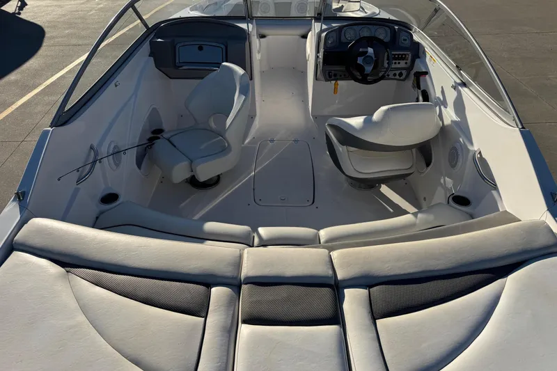 Slide: The Image of 2009 Hurricane SunDeck 210 IO boat interior with seating and steering console. - 8
